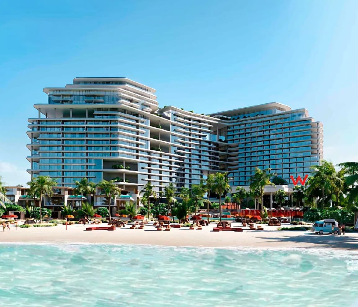 W Hotel Residences: a low-rise beachfront development along the shoreline, palms lining the sand.
